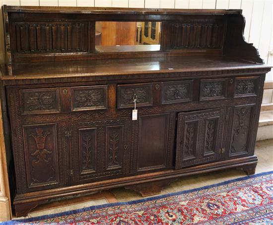 An antique Carolean style linenfold and foliate carved oak sideboard, W. 6ft 7in. D. 1ft 10in. 4ft 7in.